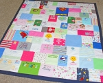 quilt made out of baby clothes