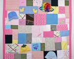 quilt made out of baby clothes