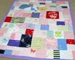 quilt made out of baby clothes