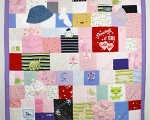 quilt made out of baby clothes