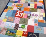 quilt with baby clothes