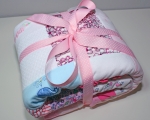 Cute baby clothes quilt in ribbon.